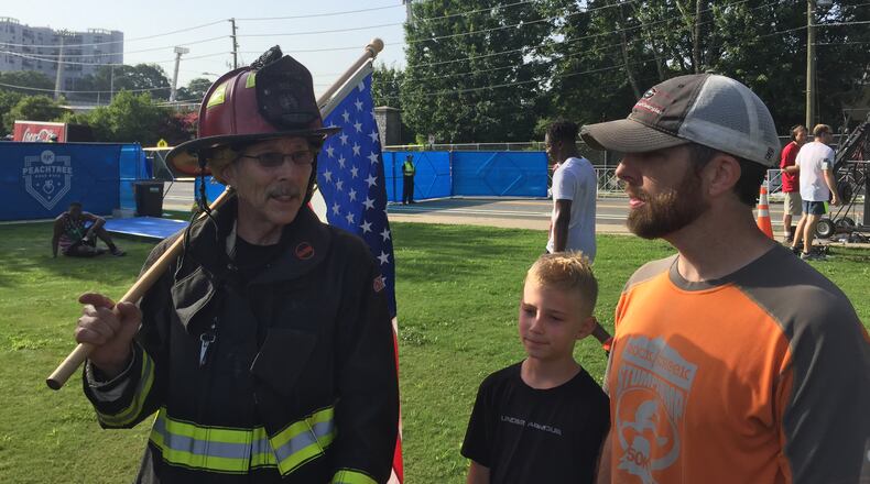 July 4, 2017- (from L-R)Johnny Buice, John Mark Buice and Josh Buice all run the AJC Peachtree Road Race. Johnny wore his old firefighters uniform while running. (Alex Makrides)