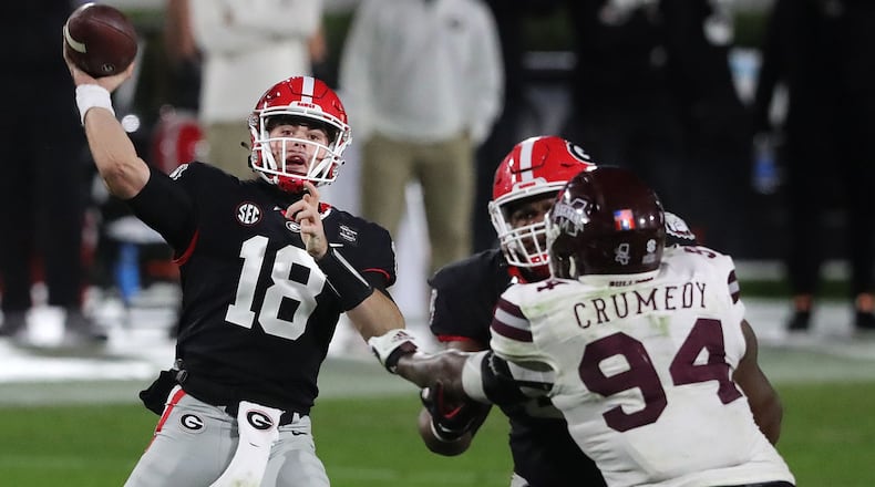 112120 Athens: Georgia quarterback JT Daniels throws for a first down Saturday, Nov. 21, 2020, at Sanford Stadium in Athens. The Georgia quarterback threw for 401 yards in his debut, a 31-24 win over Mississippi State. (Curtis Compton / Curtis.Compton@ajc.com)
