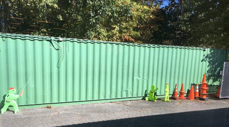 A green storage container next to the North Fulton Community Charities thrift store in Roswell is a potential canvas for an artist willing to donate his or her services to paint a mural on its side.
