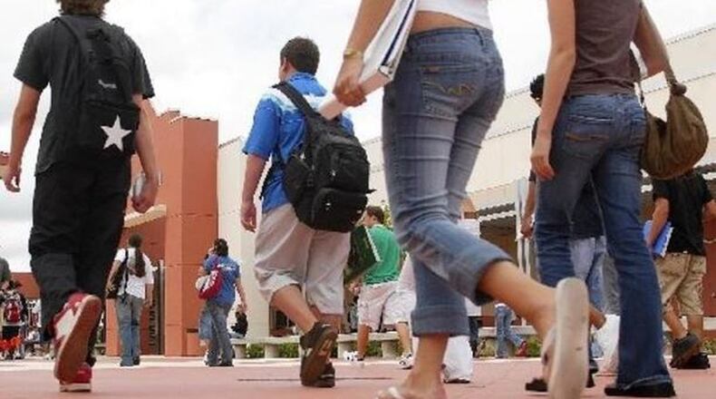 Students walking toward a school building.
