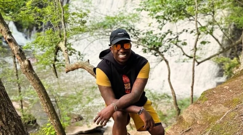 Rashad "Big Bank" Holsey, Sr. poses during a hike.
