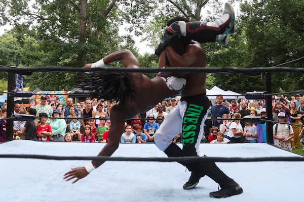 Fans watch as Deep South Wrestling’s Jay Alpha Miller throws DJ Smoke to the ground during the show at the Summer Shade Festival at Grant Park in Atlanta on Saturday, August 23, 2025. (Abbey Cutrer/AJC)