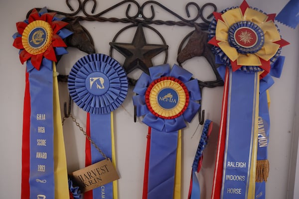 Views of prize ribbons won by Joy Lim Nakrin for racing horses  shown on Thursday, July 17, 2025. Nakrin runs Joyous Acres, a farm for rescue animals in Milton. (Natrice Miller/ AJC)