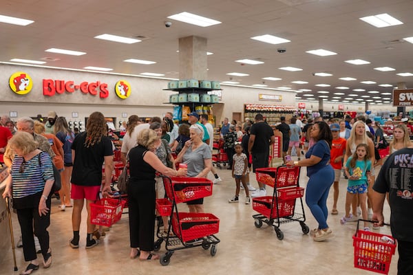 People load their carts with Buc-ee’s snacks and merchandise during the grand opening of a Buc-ee’s in Pass Christian, Mississippi, on June 9, 2025. (Emily Kask/The New York Times)
                      