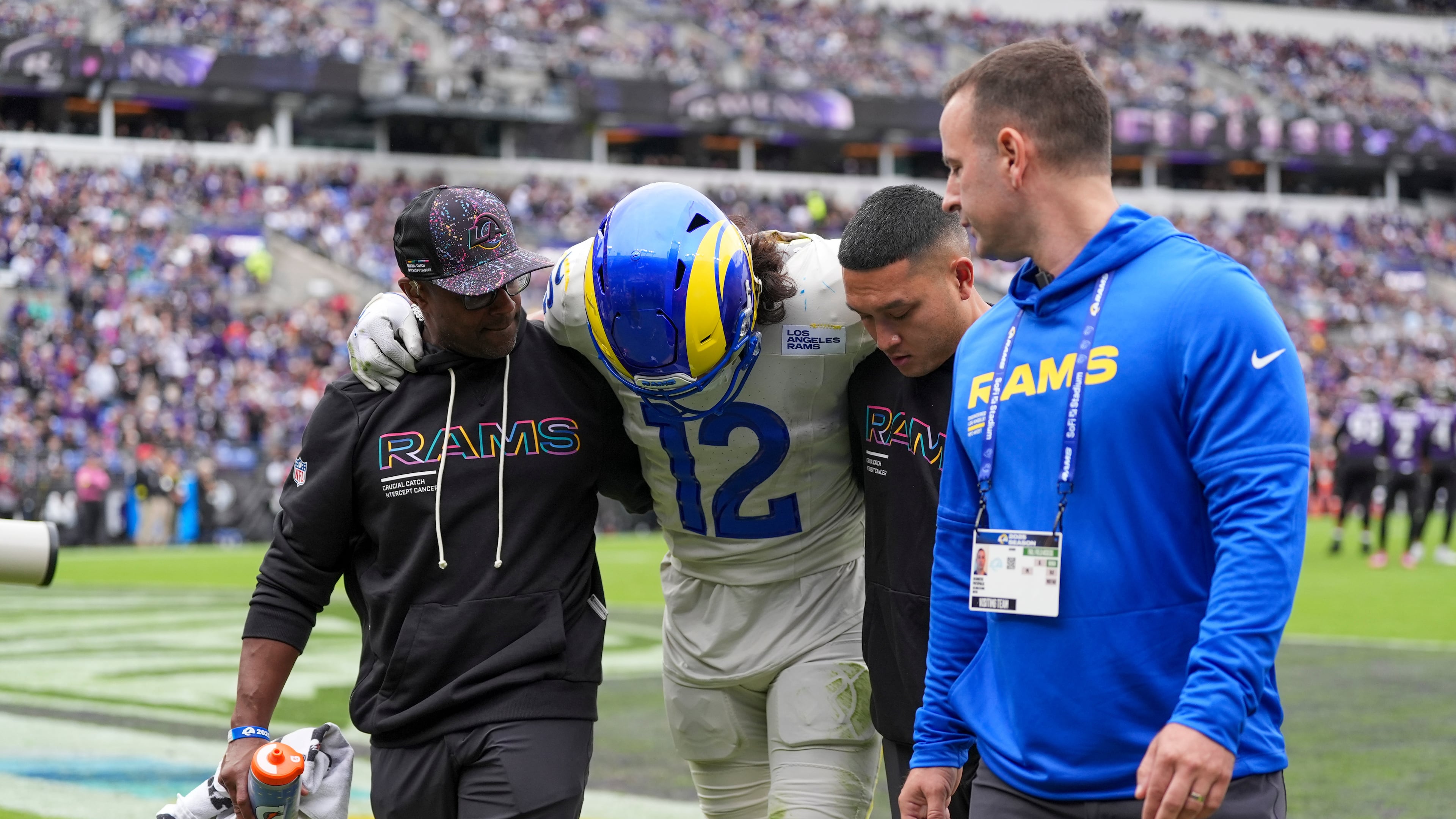 Trainers help Los Angeles Rams wide receiver Puka Nacua off the field during the first half of an NFL football game against the Baltimore Ravens Sunday, Oct. 12, 2025, in Baltimore. (AP Photo/Stephanie Scarbrough)