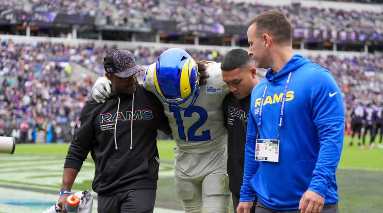Trainers help Los Angeles Rams wide receiver Puka Nacua off the field during the first half of an NFL football game against the Baltimore Ravens Sunday, Oct. 12, 2025, in Baltimore. (AP Photo/Stephanie Scarbrough)
