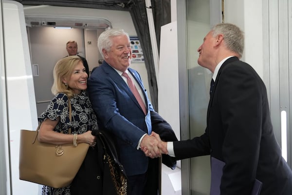 U.S. Ambassador to Japan George Glass, center, and his wife Mary are welcomed by Joseph Young, acting deputy chief of mission at the U.S. Embassy in Tokyo, upon their arrival at Haneda Airport in Tokyo Friday, April 18, 2025. (Kazuhiro Nogi/Pool Photo via AP)