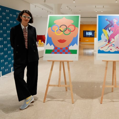 Artists Olimpia Zagnoli, left, and Carolina Altavilla pose next to Milano-Cortina 2026 Winter Olympics iconic posters presented during a press conference at Milan's Triennale permanent exhibition in Milan, Italy, Wednesday, Oct. 22, 2025. (AP Photo/Luca Bruno)