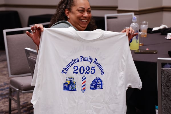 Claudine Decuir holds up the family reunion T-shirt during the Thornton Family Reunion held in Atlanta on Saturday, June 28, 2025. (Natrice Miller/AJC)