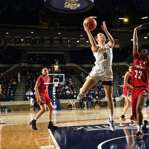 UConn guard Kayleigh Heckel (9) shoots as Louisville guard Tajianna Roberts (22) defends during the first half of a NCAA college basketball game, Tuesday, Nov. 4, 2025, in Annapolis, Md. (AP Photo/Gail Burton)