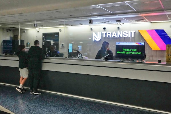 People stand at the train ticket counter of NJ Transit at Penn Station, amid a strike by New Jersey Transit train engineers, in New York, Friday, May 16, 2025. (AP Photo/Richard Drew)