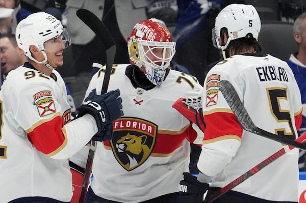 Florida Panthers goaltender Sergei Bobrovsky (72) speaks with teammates Tomas Nosek (92) and Aaron Ekblad (5) during the third period of Game 7 of a second-round NHL hockey playoff series in Toronto, Sunday, May 18, 2025. (Frank Gunn/The Canadian Press via AP)