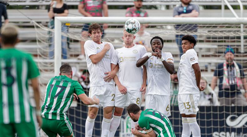 A wall comprised of Atlanta United 2's Aiden McFadden (2), Chris Allan (8), Bradley Kamdem Fewo (6) and Caleb Wiley (13) attempt to block a penalty kick by Oklahoma City Energy's Jonathan Brown (17) during a USL Championship match Sunday, May 16, 2021, at Taft Stadium in Oklahoma City, Okla.
