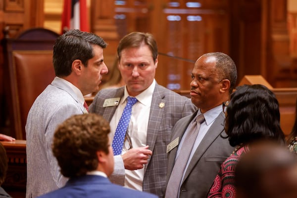 State Rep. Chuck Efstration (left), R-Mulberry, and Rep. David Wilkerson (right), D-Powder Springs, confer before a vote on property tax legislation during the special session in the House of Representatives at the Capitol in Atlanta on Saturday, June 20, 2026. (Arvin Temkar/AJC)