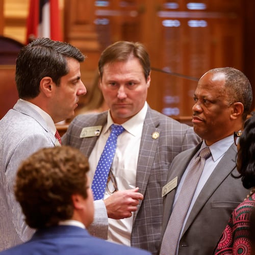 State Rep. Chuck Efstration, left, R-Mulberry, and Rep. David Wilkerson, right, D-Powder Springs, confer before a vote on property tax legislation during the special session in the House of Representatives at the Capitol in Atlanta. (Arvin Temkar/AJC)