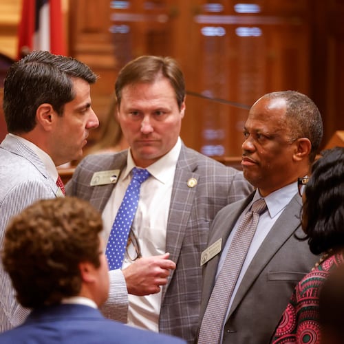 State Rep. Chuck Efstration, left, R-Mulberry, and Rep. David Wilkerson, right, D-Powder Springs, confer before a vote on property tax legislation during the special session in the House of Representatives at the Capitol in Atlanta. (Arvin Temkar/AJC)