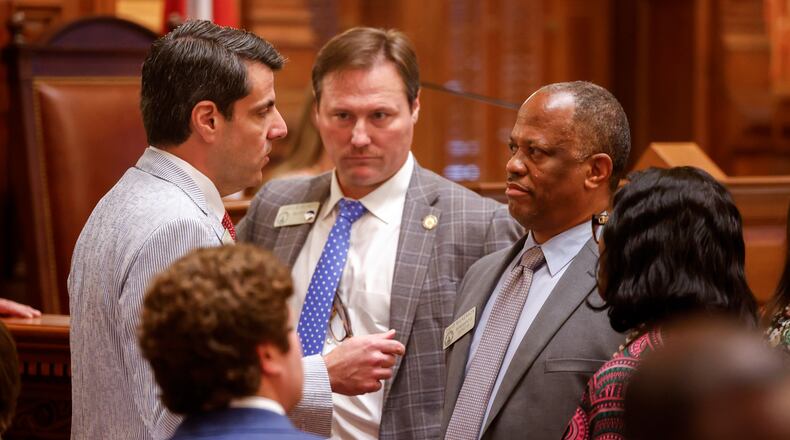 State Rep. Chuck Efstration, left, R-Mulberry, and Rep. David Wilkerson, right, D-Powder Springs, confer before a vote on property tax legislation during the special session in the House of Representatives at the Capitol in Atlanta. (Arvin Temkar/AJC)