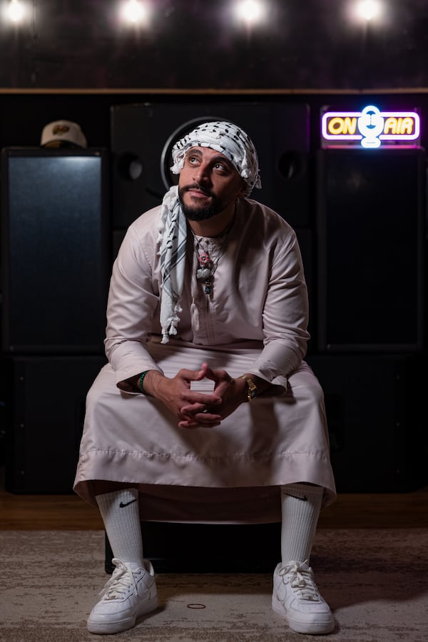 Faris Mousa, 35, wears a thobe and keffiyah at Tree Sound Studios in Norcross. (Arvin Temkar/AJC)