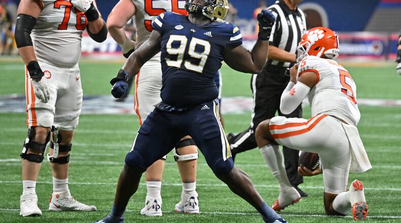 Georgia Tech defensive lineman D'Quan Douse (99) reacts after taking down Clemson's quarterback DJ Uiagalelei (5) during the first half of Chick-fil-A Kickoff game at Mercedes-Benz Stadium in Atlanta on Monday, Sept. 5, 2022. (Hyosub Shin / Hyosub.Shin@ajc.com)