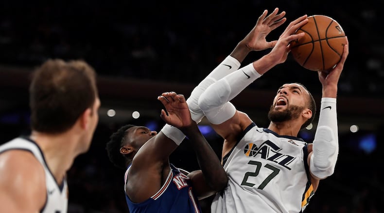 Utah Jazz center Rudy Gobert (27) shoots as New York Knicks forward Bobby Portis (1) defends during the second half of an NBA basketball game in New York, Wednesday, March 4, 2020. (AP Photo/Sarah Stier)