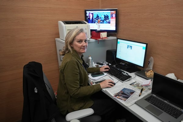 Associated Press correspondent Nicole Winfield works in the Vatican's press room Thursday, April 24, 2025. (AP Photo/Alessandra Tarantino)