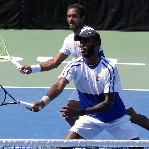 India's Dhakshineswar Suresh, front, returns the ball as his teammate N Sriram Balaji watches during a double match of a Davis Cup World second-round qualifier against South Korea's Nam Jisung and Park Uisung in Seoul, South Korea, Saturday, Sept. 19, 2026. (AP Photo/Ahn Young-joon)
