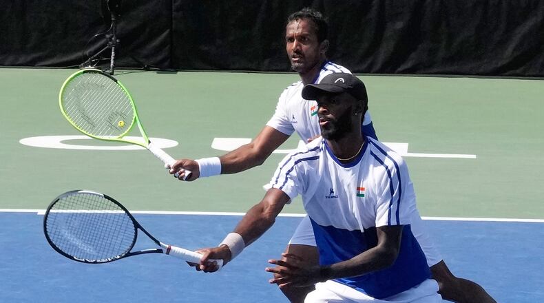 India's Dhakshineswar Suresh, front, returns the ball as his teammate N Sriram Balaji watches during a double match of a Davis Cup World second-round qualifier against South Korea's Nam Jisung and Park Uisung in Seoul, South Korea, Saturday, Sept. 19, 2026. (AP Photo/Ahn Young-joon)