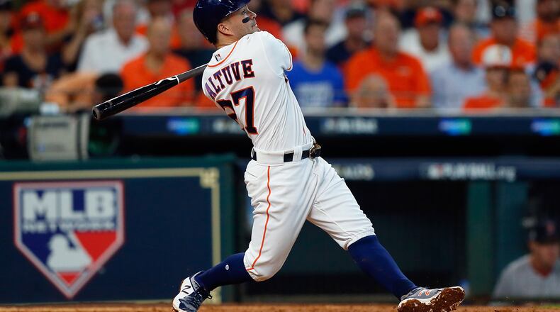 Astros second baseman Jose Altuve hits a home run in the fifth inning against the Red Sox during game one of the American League Division Series at Minute Maid Park on Thursday afternoon in Houston, Texas.