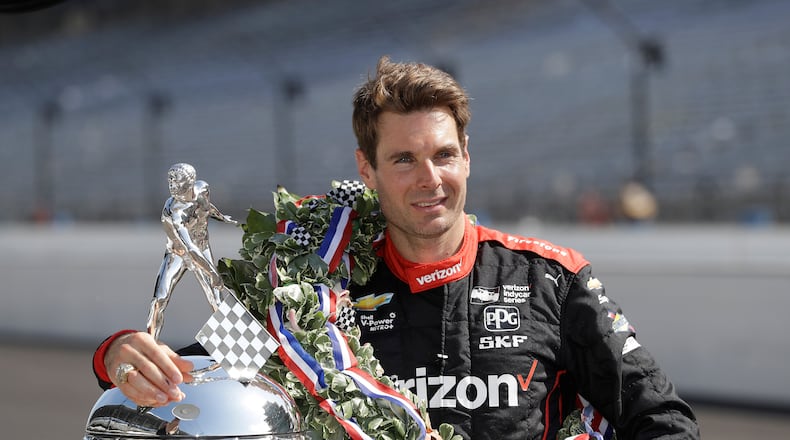 FILE Indianapolis 500 champion Will Power, of Australia, poses with the Borg-Warner Trophy during the traditional winners photo session on the start/finish line at the Indianapolis Motor Speedway, May 28, 2018, in Indianapolis. (AP Photo/Darron Cummings, File)