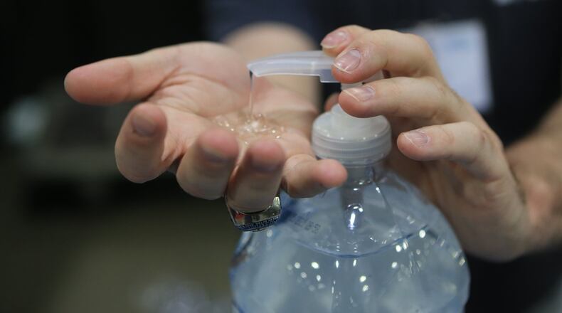 Aaron Sones uses hand sanitizer during the Construction Education Foundation of Georgia career expo on Thursday, March 12, 2020, at the Georgia World Congress Center in Atlanta. (Christina Matacotta for The Atlanta Journal-Constitution).