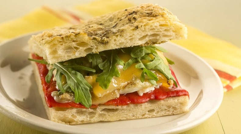 This twist on a pepper and egg sandwich has all the elements of the traditional version, but also adds olive tapenade, cheese and fresh arugula. (Bill Hogan/Chicago Tribune/TNS)