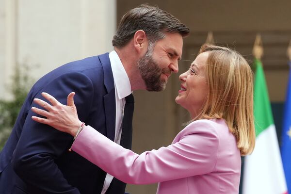 U.S. Vice President JD Vance, left, is welcomed by Italian Premier Giorgia Meloni as he arrives for talks at Palazzo Chigi government office in Rome, Friday, April 18, 2025. (AP Photo/Andrew Medichini)