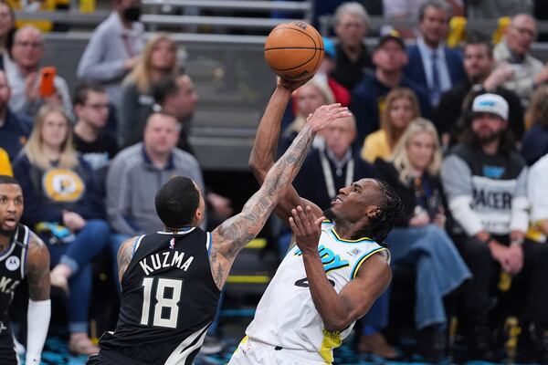 Indiana Pacers forward Aaron Nesmith (23) shoots over Milwaukee Bucks forward Kyle Kuzma (18) during the second half of a first-round NBA basketball playoff game in Indianapolis, Tuesday, April 22, 2025. (AP Photo/Michael Conroy)