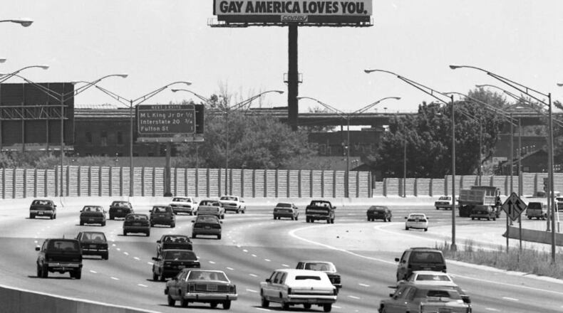 A billboard "Gay America Loves You," billboard, looking south down the Downtown Connector, Atlanta, Georgia, June 20, 1990. PHOTO BY WILLIAM BERRY / AJC ARCHIVES