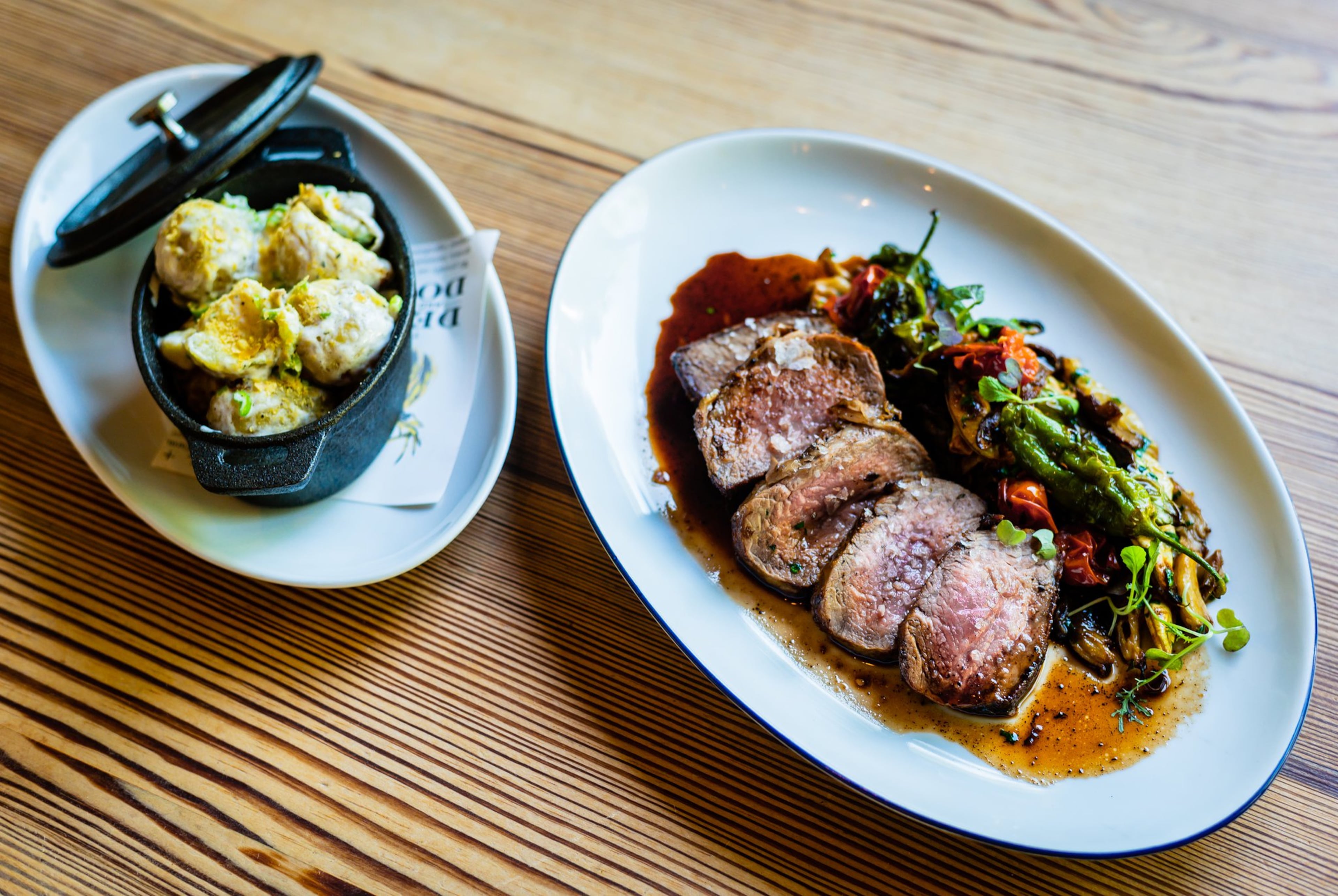 The Deer and the Dove is known for its uncommon cuts of meat, but the menu includes plenty of standard fare like this ribeye served with a side of beef-fat potatoes with sour cream. (Henri Hollis/AJC)