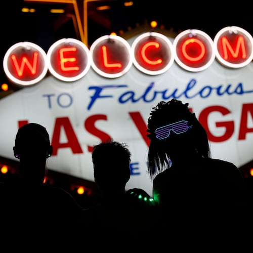FILE - Runners stop to to have photos taken by official photographers at the Welcome to Las Vegas sign during the Rock 'n' Roll Las Vegas Marathon, Sunday, Nov. 12, 2017, in Las Vegas. (AP Photo/John Locher, File)