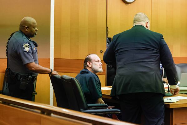 Jay Berger looks at his attorney, Stuart Mones, after a magistrate judge granted him bond.