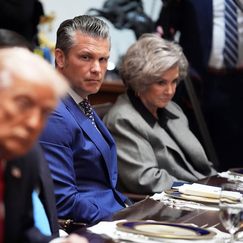 Defense Secretary Pete Hegseth listens as he and White House Chief of Staff Susie Wiles, right, listen during a meeting with President Donald Trump, in foreground left, and Australian Prime Minister Anthony Albanese in the Cabinet Room of the White House, Monday, October 20, 2025, in Washington. (AP Photo/Evan Vucci)