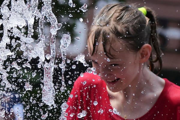 Bay Puro cools off at a fountain during hot weather in Chicago, Sunday, June 22, 2025. (AP Photo/Nam Y. Huh)