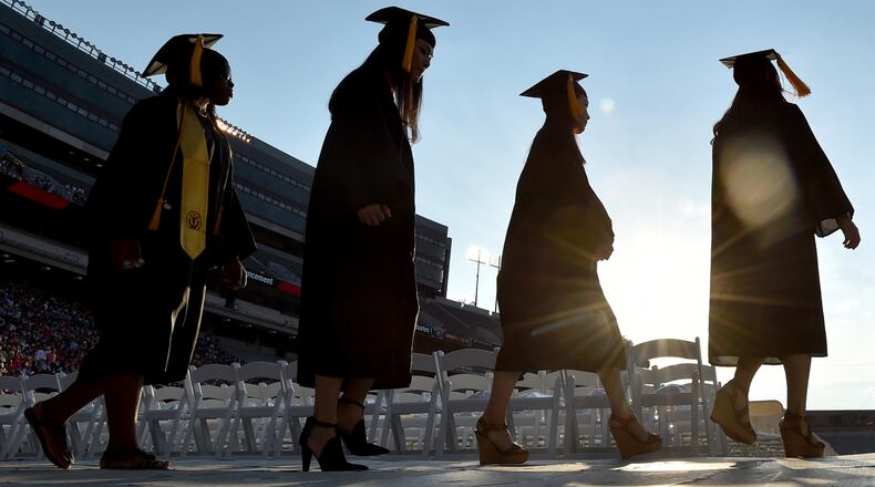 SUNSET ON THEIR COLLEGE CAREERS--May 8, 2015 Athens, GA: University of Georgia graduates file into Sanford Stadium for the undergraduate commencement Friday May 8, 2015. Almost 4500 undergraduates had their degrees conferred during the ceremony. BRANT SANDERLIN/BSANDERLIN@AJC.COM