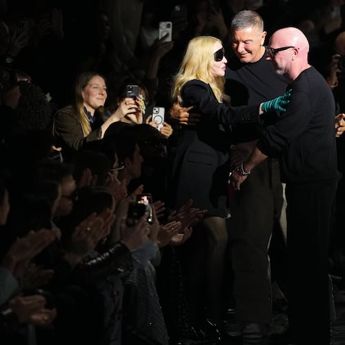 Madonna congratulates Domenico Dolce, right, and Stefano Gabbana at the end of the Dolce & Gabbana Fall/Winter 2026-2027 Women's collection, presented in Milan, Italy, Saturday, Feb. 28, 2026. (AP Photo/Antonio Calanni)