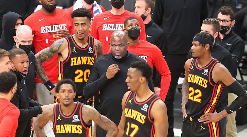 Hawks interim head coach Nate McMillan and Lou Williams (from left), John Collins, Onyeka Okongwu, and Cam Reddish look for answers during a time out against the Milwaukee Bucks during the third quarter in game 5 of the NBA Eastern Conference Finals on Thursday, July 1, 2021, in Milwaukee.   “Curtis Compton / Curtis.Compton@ajc.com”