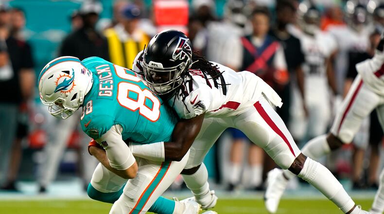 Atlanta Falcons safety Dwayne Johnson Jr. (37) tackles Miami Dolphins tight end Mike Gesicki (88) during the first half of a NFL preseason football game, Saturday, Aug. 21, 2021, in Miami Gardens. (AP Photo/Wilfredo Lee)