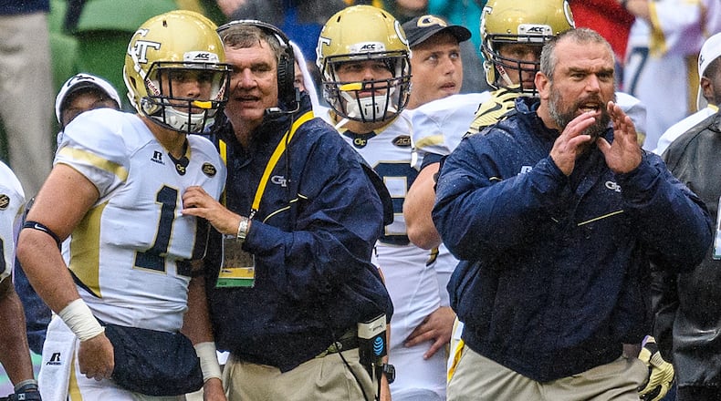 In this photo released by Georgia Tech, Georgia Tech coach Paul Johnson, second from left, gives quarterback Matthew Jordan (11) the next play during the first half of an NCAA college football game against Boston College, Saturday, Sept. 3, 2016, in Dublin, Ireland. (Danny Karnik/Georgia Tech via AP)