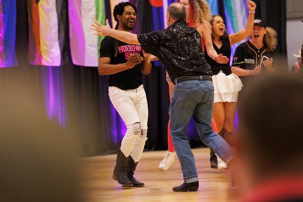 Raques McGill (left) celebrates after winning the golden hoe in the advance line dance contest during the Hoedown South convention held by DanceOut Atlanta, Aug. 1, 2026 in Atlanta. (Estela Muñoz/AJC) 

