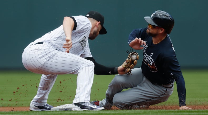 Colorado Rockies shortstop Trevor Story, left, applies a late tag on Atlanta Braves’ Ender Inciarte as Inciarte steals second base in the first inning of a baseball game Thursday, Aug. 17, 2017, in Denver. (AP Photo/David Zalubowski)