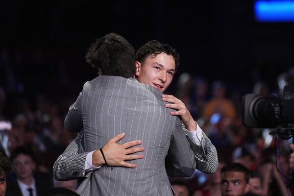 Matthew Schaefer, right, is congratulated after being drafted by the New York Islanders during the NHL hockey draft Friday, June 27, 2025, in Los Angeles. (AP Photo/Damian Dovarganes)