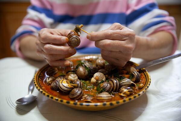A Tunisian woman eats a meal of snails to break her Ramadan fast, in Sfax, Tunisia, March 29, 2025. (AP Photo/Ons Abid)