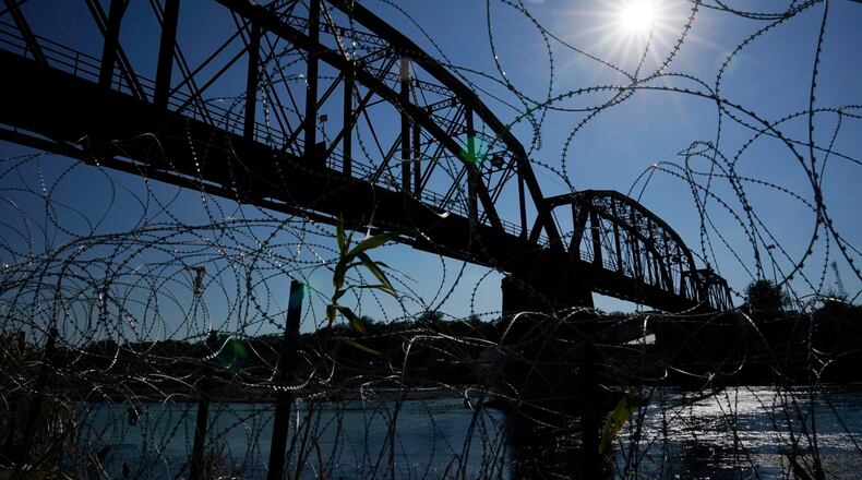 FILE - The Union Pacific International Railroad Bridge is seen behind concertina wire, Sept. 22, 2023, in Eagle Pass, Texas. (AP Photo/Eric Gay, File)