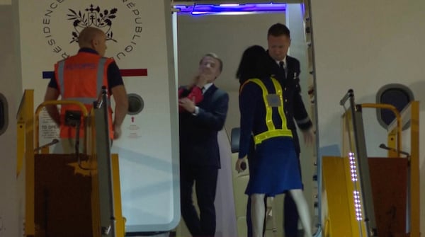 In this grab taken from video, France's President Emmanuel Macron prepares to disembark a plane on arrival, in Hanoi, Vietnam, Sunday, May 25, 2025. (AP Photo/Hau Dinh)